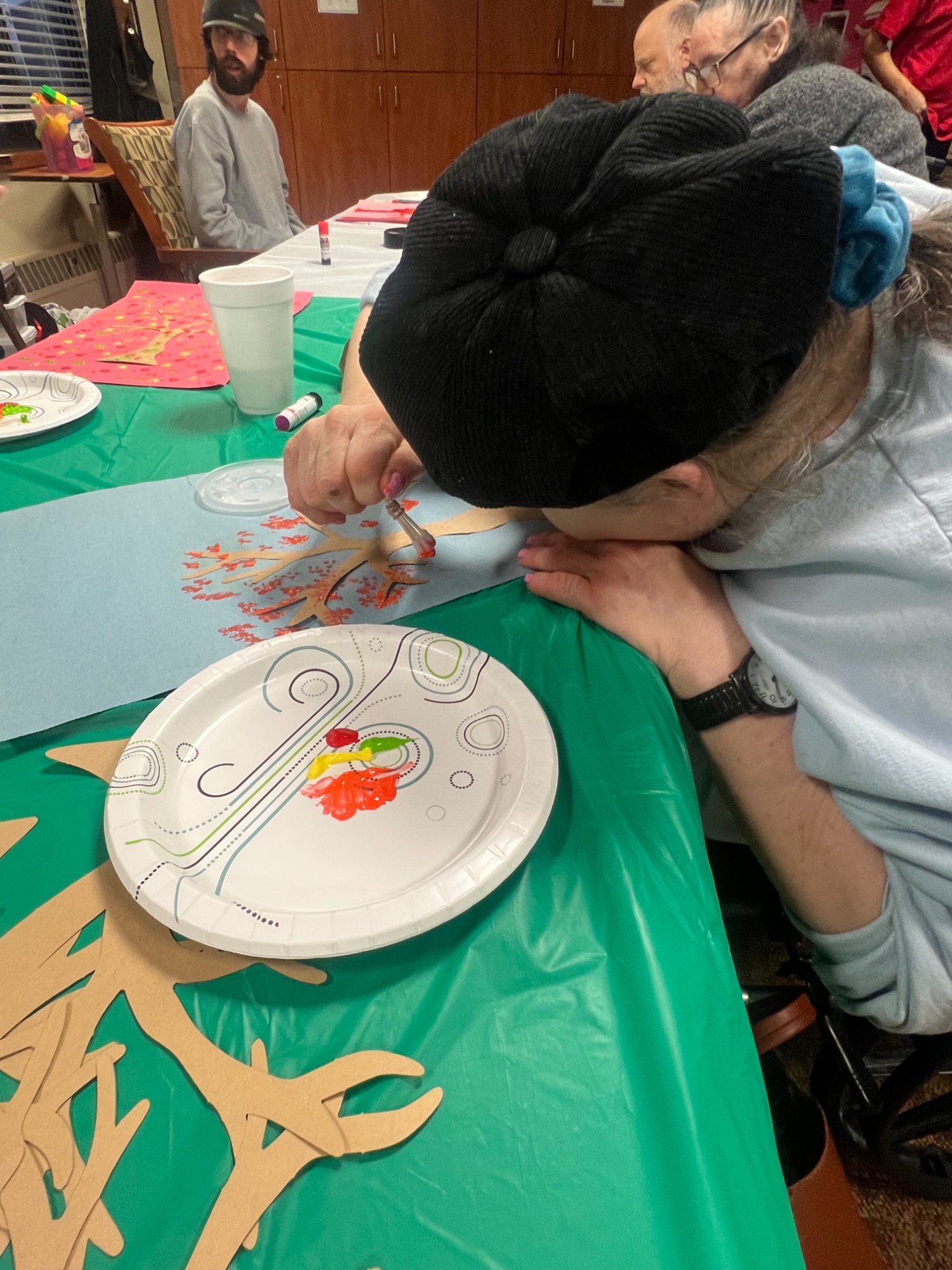 Resident doing arts and crafts with volunteer